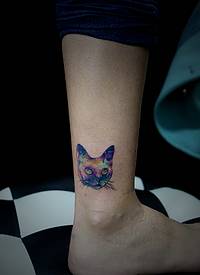 小腿看似很惊讶的小花猫头像纹身
