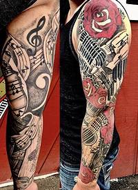 欧美花臂纹身 男生手臂上花朵和吉他纹身图片